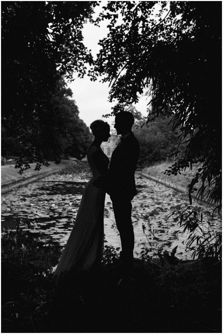 Bride and groom silhouette among the trees 