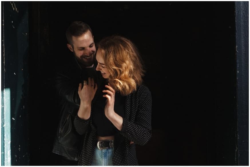 couple engagement shoot laugh during an embrace 