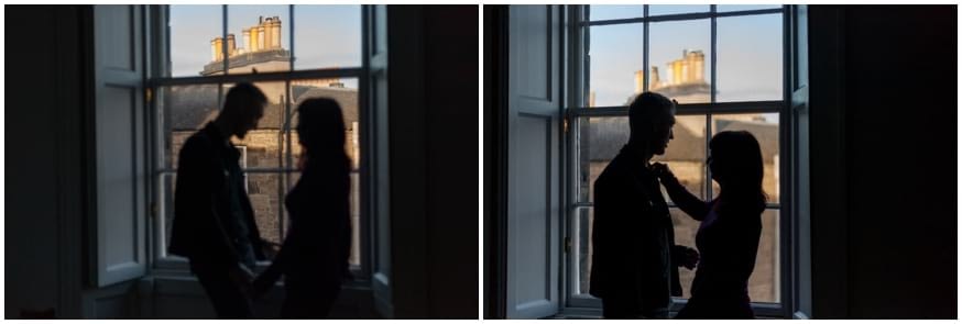 Couple peer out the window during their engagement shoot in Edinburgh city