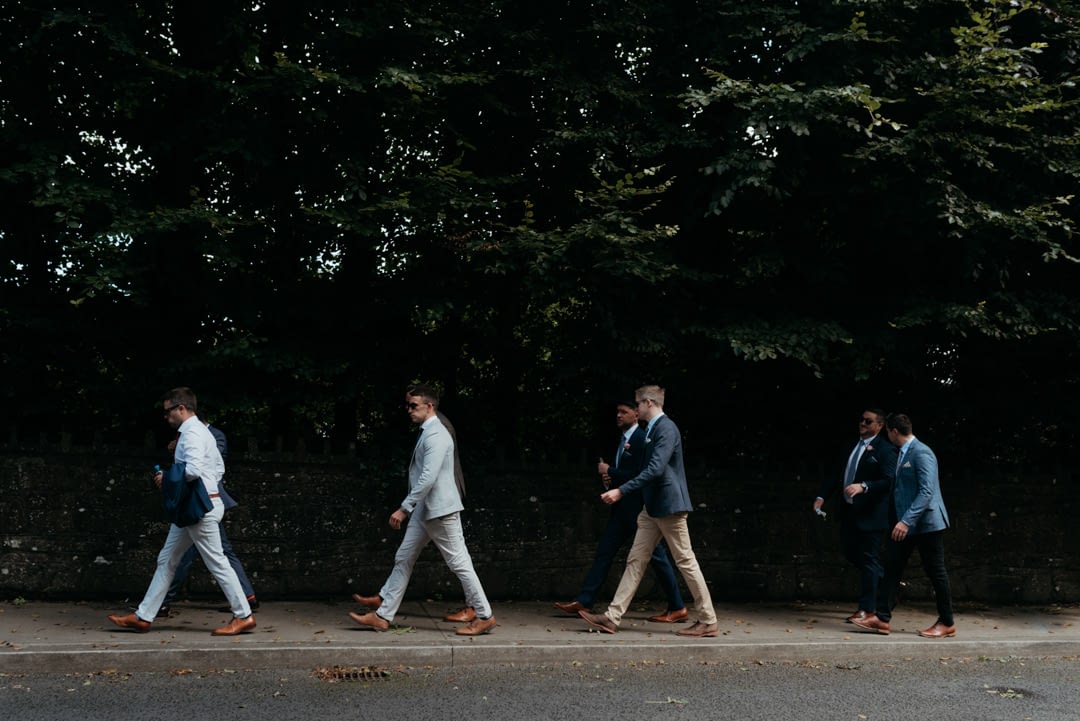 Groom and his groomsmen walk to the church in Dublin 